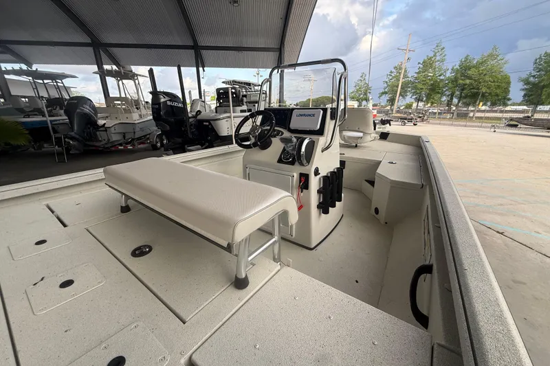Slide: The Image of 2026 Ranger RB190 boat interior with console, seating, and storage under a covered area. - 8