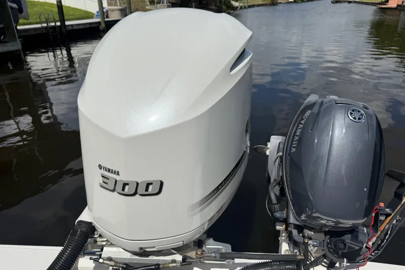 Slide: The Image of Yamaha 300 outboard engines on a 2019 Ranger Tugs R-27 boat by the water. - 10