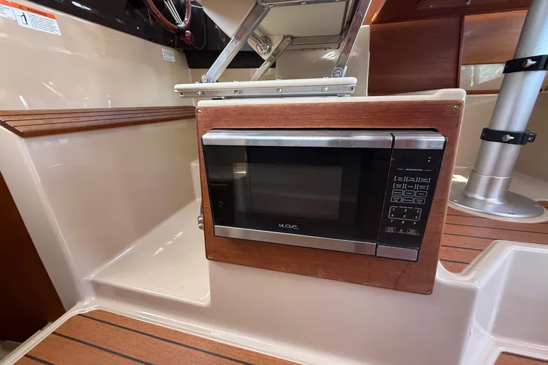 Slide: The Image of Microwave in 2019 Ranger Tugs R-27 boat interior, featuring wood accents and modern design. - 24