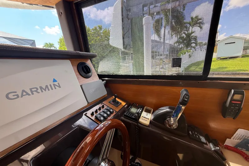 Slide: The Image of Interior view of 2019 Ranger Tugs R-27 helm with Garmin navigation system. - 27