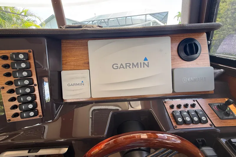 Slide: The Image of 2019 Ranger Tugs R-27 dashboard featuring Garmin and Yamaha controls. - 28