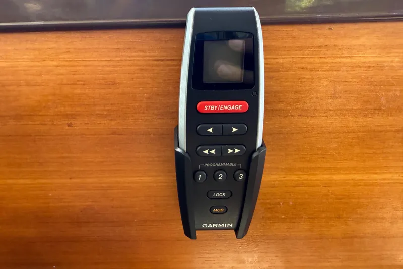 Slide: The Image of Garmin remote control on Ranger Tugs R-27, 2019 model, mounted on wooden surface. - 34