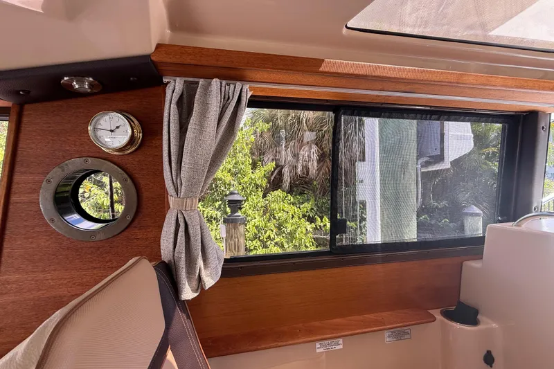 Slide: The Image of Interior view of 2019 Ranger Tugs R-27 boat with window and clock. - 35