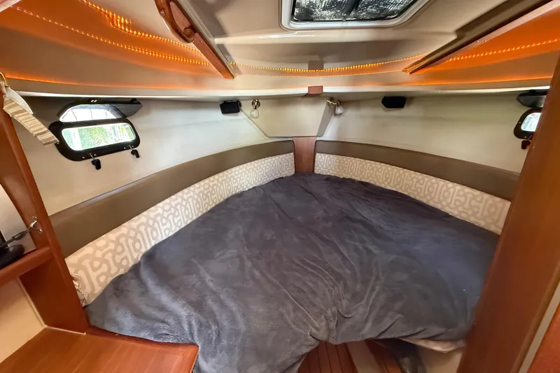 Slide: The Image of Cozy cabin interior of 2019 Ranger Tugs R-27 with comfortable bedding and ambient lighting. - 38