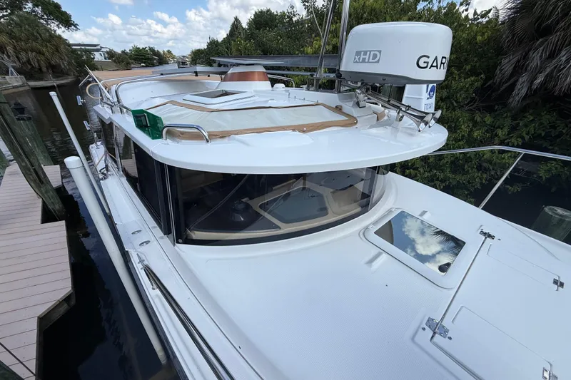 Slide: The Image of 2019 Ranger Tugs R-27 boat docked, featuring Garmin radar and sleek design. - 4