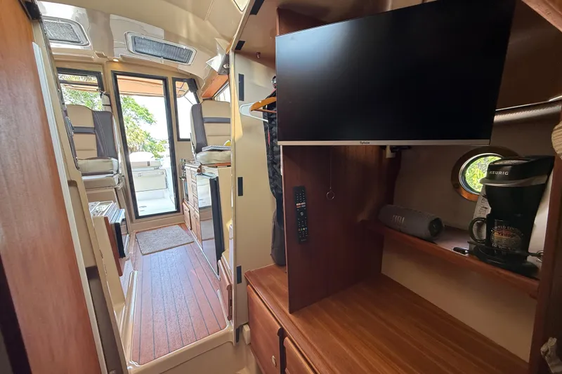 Slide: The Image of Interior of 2019 Ranger Tugs R-27 boat with TV and kitchenette. - 40