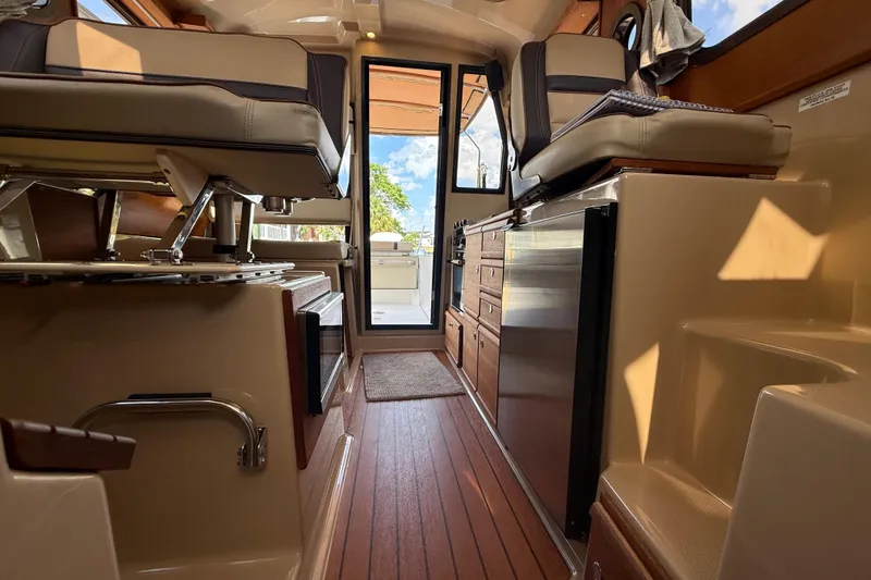 Slide: The Image of Interior of 2019 Ranger Tugs R-27 boat with wood flooring and modern seating. - 41