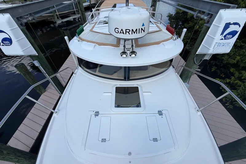 Slide: The Image of 2019 Ranger Tugs R-27 boat docked, featuring Garmin equipment on deck. - 5