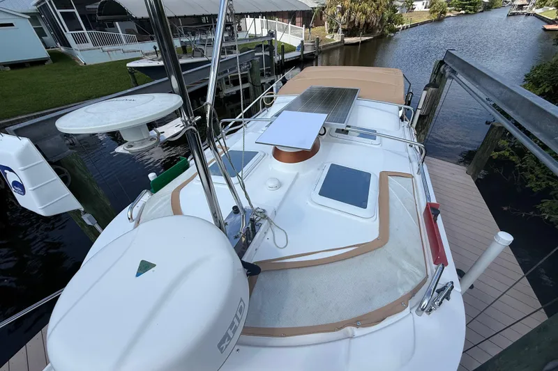 Slide: The Image of 2019 Ranger Tugs R-27 boat docked, featuring solar panels and radar equipment. - 6