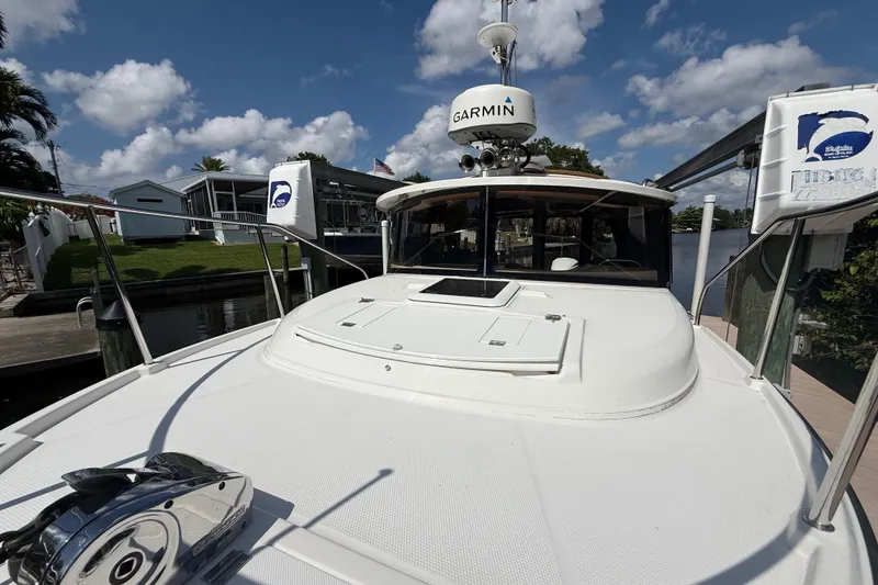 Slide: The Image of 2019 Ranger Tugs R-27 boat docked, featuring Garmin equipment under a partly cloudy sky. - 7