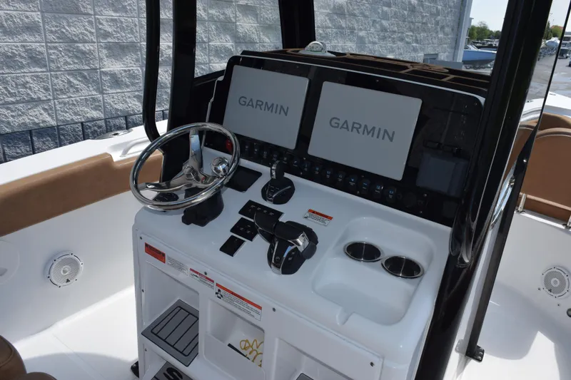 Slide: The Image of 2022 Sea Hunt Gamefish 27 helm with dual Garmin displays and steering wheel. - 10