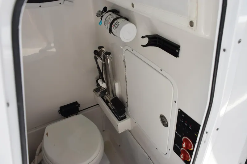 Slide: The Image of 2022 Sea Hunt Gamefish 27 boat interior with toilet and safety equipment. - 15