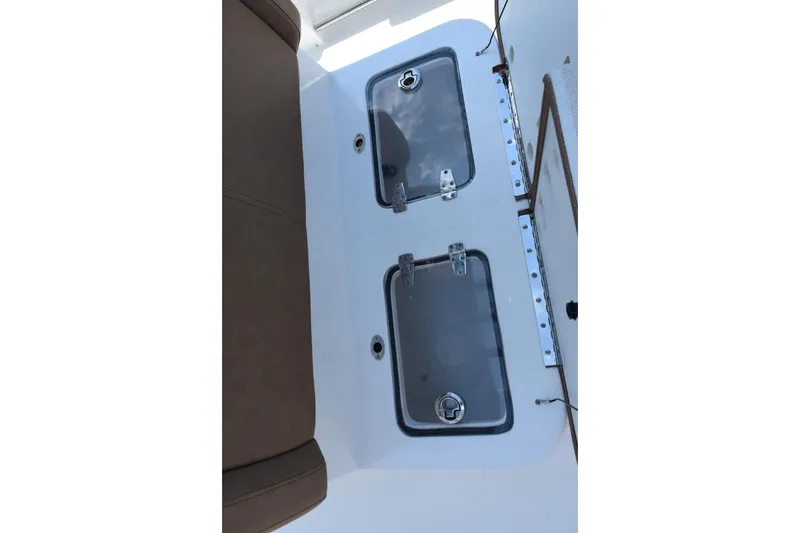 Slide: The Image of 2022 Sea Hunt Gamefish 27 Forward Seating storage compartments with transparent lids. - 19