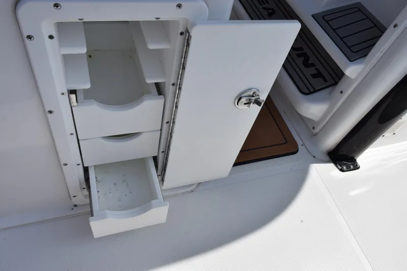 Slide: The Image of Storage compartment with open drawers on a 2022 Sea Hunt Gamefish 27 boat. - 23