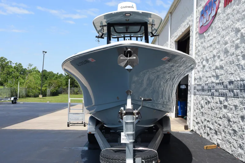 Slide: The Image of 2022 Sea Hunt Gamefish 27 boat on trailer outside a building. - 3