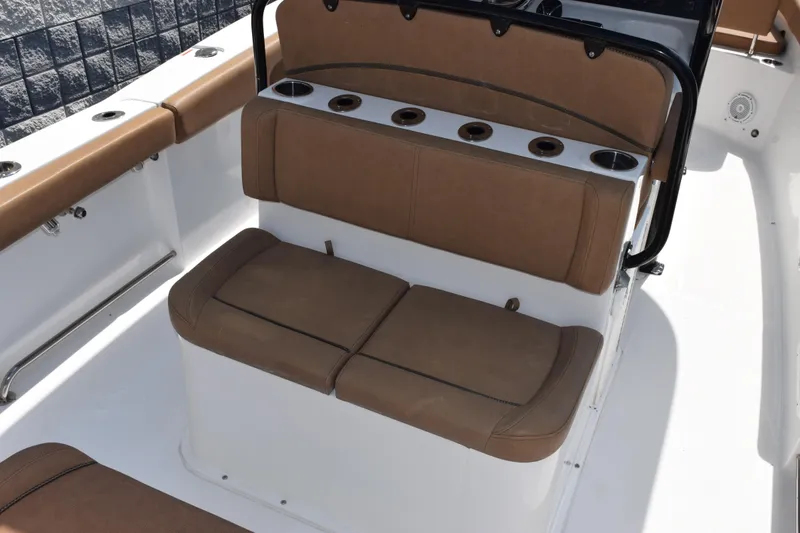 Slide: The Image of 2022 Sea Hunt Gamefish 27 boat with brown cushioned forward seating and cup holders. - 8