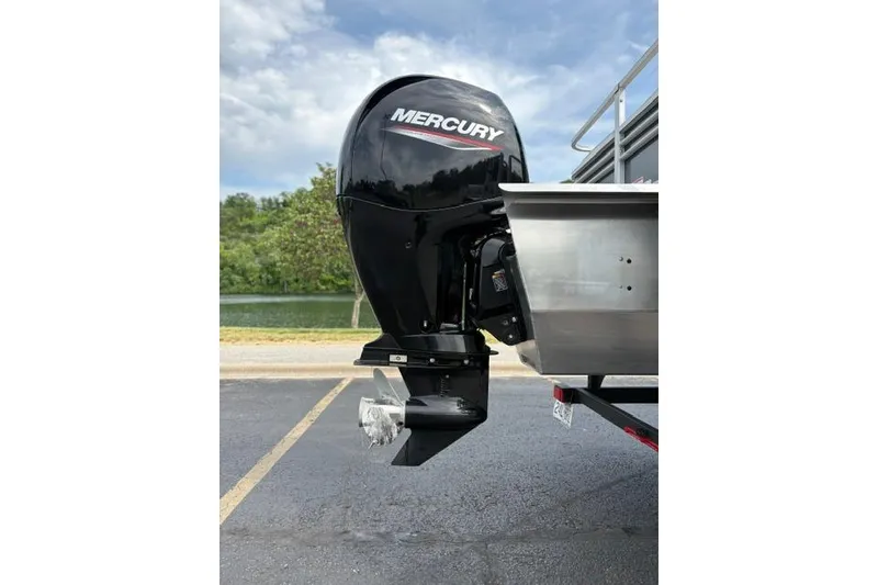 Slide: The Image of 2022 Sun Tracker Fishin' Barge 22 XP3 with Mercury outboard motor by a lake. - 10