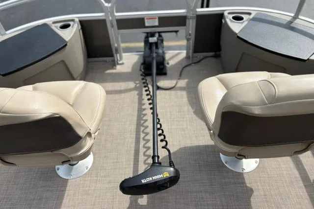 Slide: The Image of 2022 Sun Tracker Fishin' Barge 22 XP3 interior with Minn Kota trolling motor and seating. - 13
