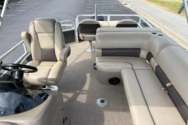 Slide: The Image of 2022 Sun Tracker Fishin' Barge 22 XP3 interior with beige seating and steering console. - 17