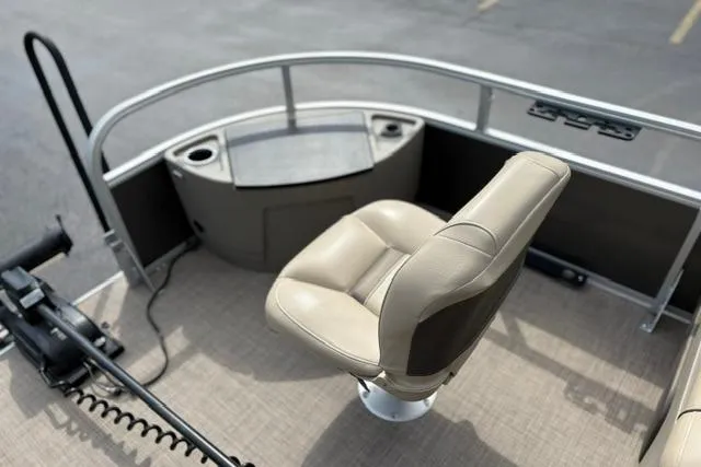 Slide: The Image of 2022 Sun Tracker Fishin' Barge 22 XP3 with beige seating and fishing equipment. - 22