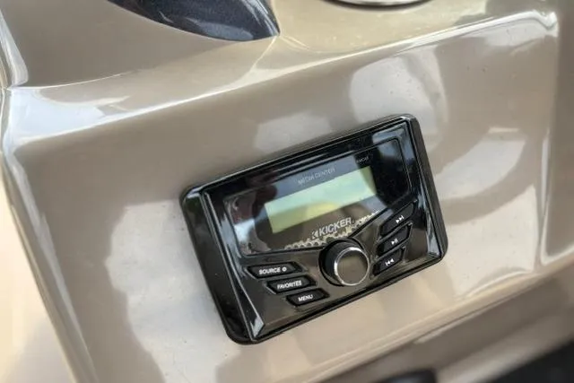 Slide: The Image of Kicker audio system on 2022 Sun Tracker Fishin' Barge 22 XP3 dashboard. - 23