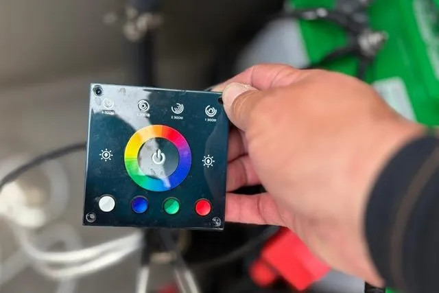Slide: The Image of Control panel for 2022 Sun Tracker Fishin' Barge 22 XP3, featuring colorful LED settings. - 25