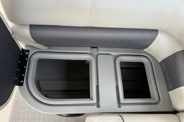 Slide: The Image of Storage compartment on 2022 Sun Tracker Fishin' Barge 22 XP3 boat, featuring cushioned seating. - 28