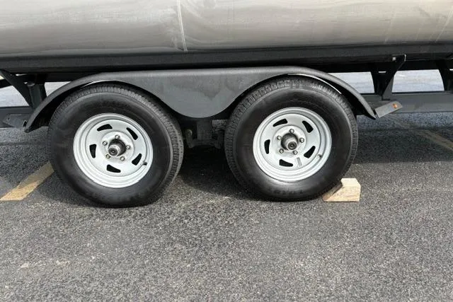 Slide: The Image of Trailer wheels of 2022 Sun Tracker Fishin' Barge 22 XP3 on pavement. - 33