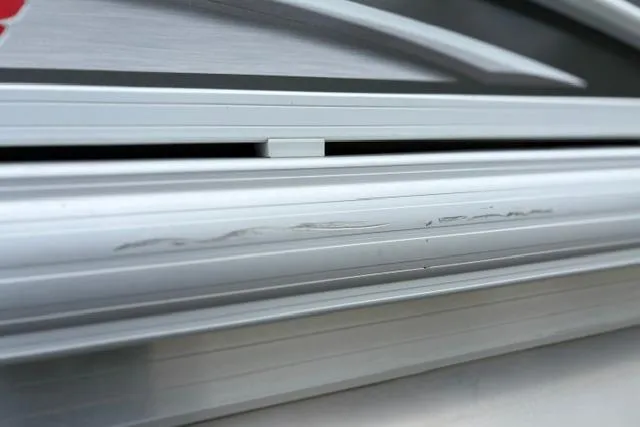 Slide: The Image of Close-up of 2022 Sun Tracker Fishin' Barge 22 XP3 aluminum siding with visible scratches. - 35