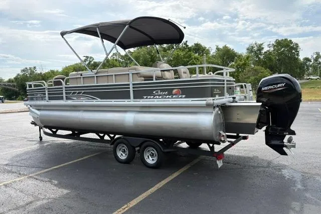 Slide: The Image of 2022 Sun Tracker Fishin' Barge 22 XP3 pontoon boat on trailer in parking lot. - 5