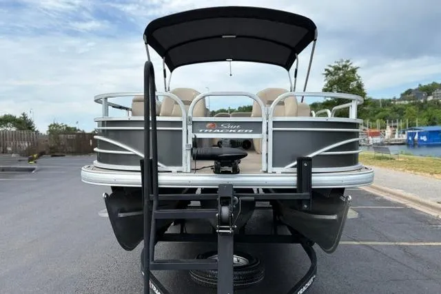 Slide: The Image of 2022 Sun Tracker Fishin' Barge 22 XP3 pontoon boat, rear view in parking lot. - 6
