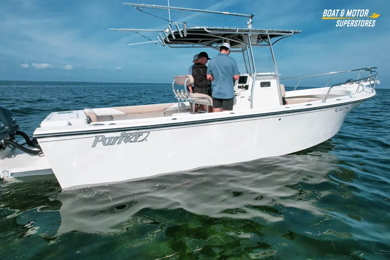 Slide: The Image of 2015 Parker 2801 Center Console boat on open water, two people onboard, clear sky. - 12