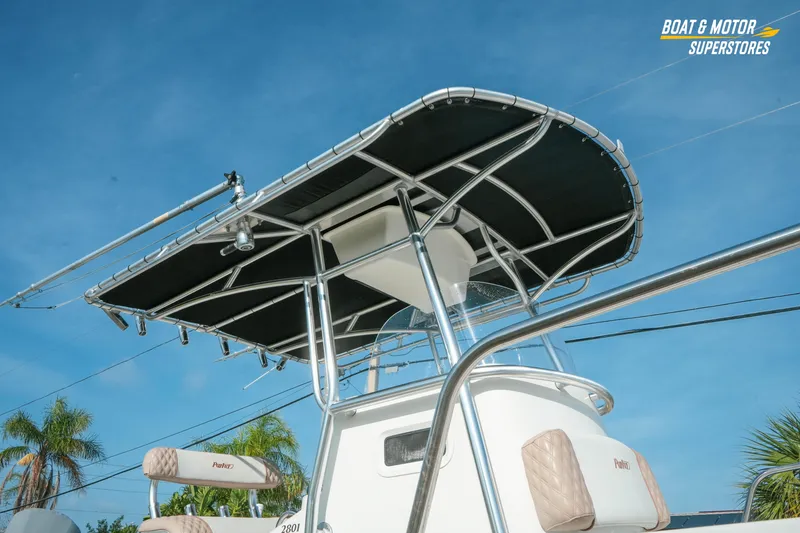 Slide: The Image of 2015 Parker 2801 Center Console boat with T-top under clear blue sky. - 15