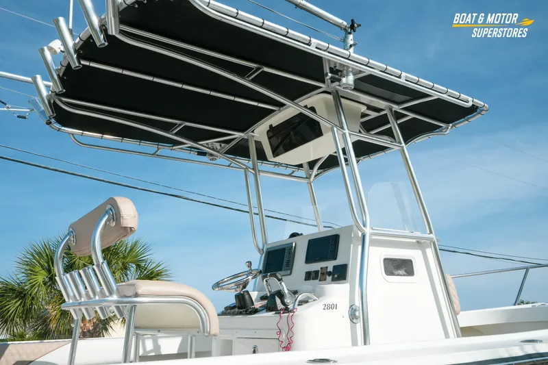 Slide: The Image of 2015 Parker 2801 Center Console boat with T-top and helm, clear sky background. - 17