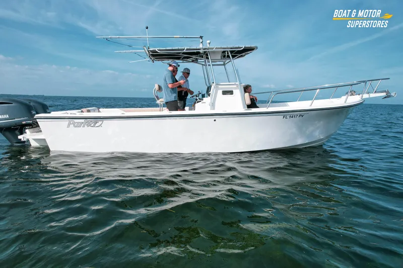 Slide: The Image of 2015 Parker 2801 Center Console boat on open water, featuring Yamaha engines. - 2