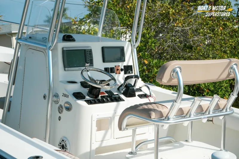 Slide: The Image of 2015 Parker 2801 Center Console boat dashboard with steering wheel and navigation equipment. - 21