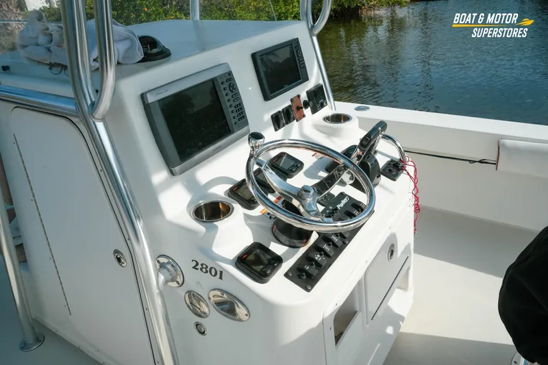 Slide: The Image of 2015 Parker 2801 Center Console boat dashboard with steering wheel and navigation equipment. - 24