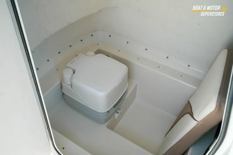 Slide: The Image of 2015 Parker 2801 Center Console boat interior with portable toilet and seating. - 26