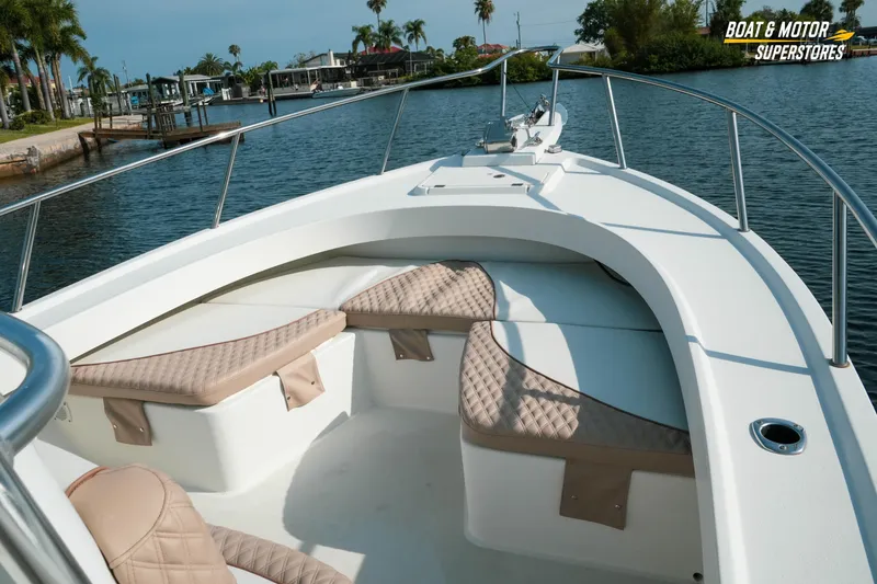 Slide: The Image of 2015 Parker 2801 Center Console boat with cushioned seating, docked near palm trees. - 35