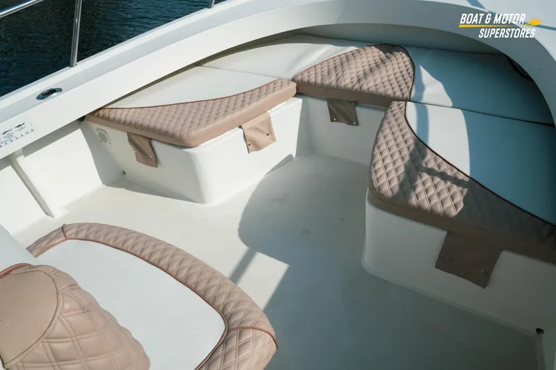 Slide: The Image of 2015 Parker 2801 Center Console boat with beige quilted seating, on calm water. - 36