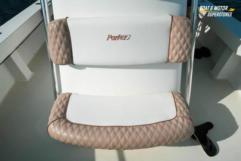 Slide: The Image of Parker 2801 Center Console 2015 boat seat with quilted beige and white upholstery. - 39