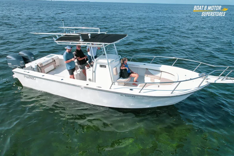 Slide: The Image of 2015 Parker 2801 Center Console boat on open water with three people onboard. - 4