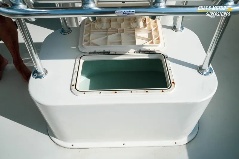 Slide: The Image of Open storage compartment on a 2015 Parker 2801 Center Console boat deck. - 42