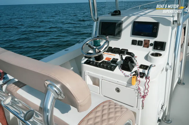 Slide: The Image of 2015 Parker 2801 Center Console boat dashboard with steering wheel and navigation equipment. - 43