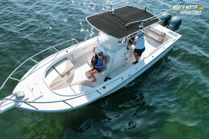 Slide: The Image of 2015 Parker 2801 Center Console boat cruising on clear water with two passengers. - 6