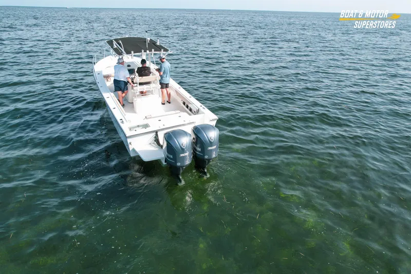 Slide: The Image of 2015 Parker 2801 Center Console boat on open water with three people onboard. - 8
