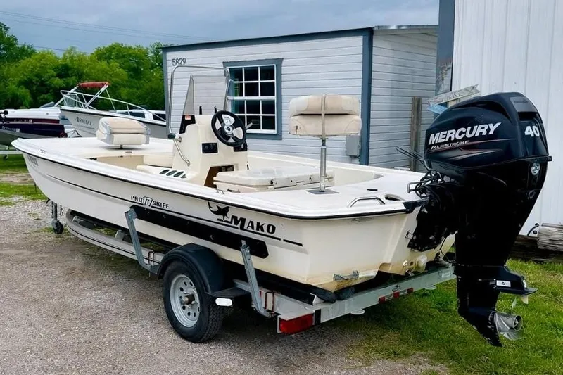 Slide: The Image of 2013 Mako Pro Skiff 17 CC boat with Mercury 40 outboard motor on trailer. - 2