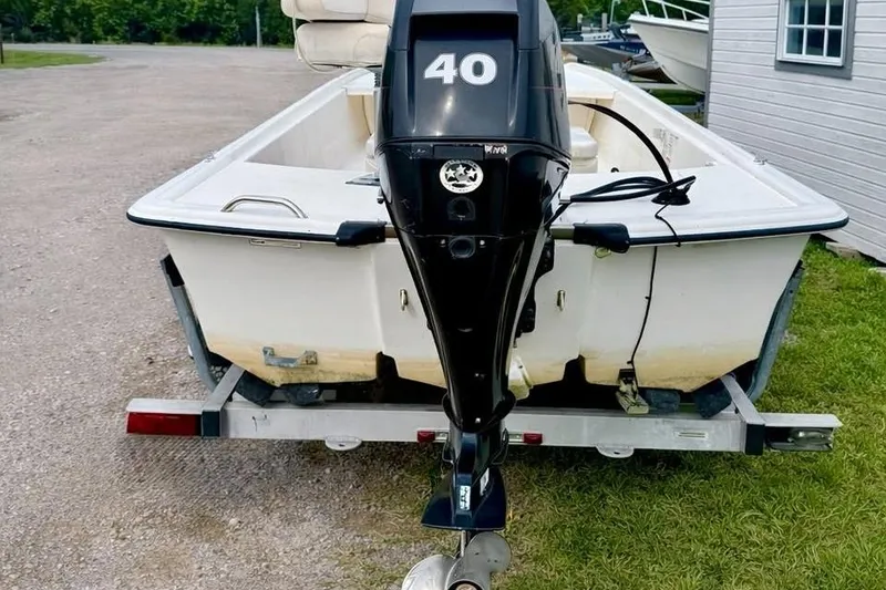 Slide: The Image of 2013 Mako Pro Skiff 17 CC boat with 40 HP outboard motor on trailer. - 3