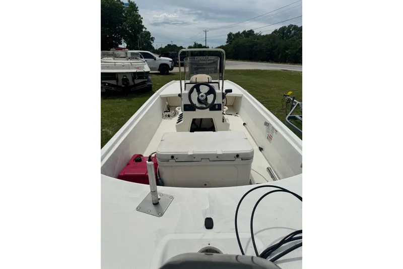 Slide: The Image of 2013 Mako Pro Skiff 17 CC boat interior with steering console and storage. - 5
