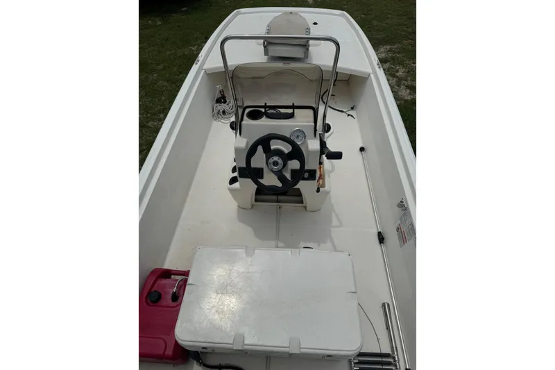 Slide: The Image of 2013 Mako Pro Skiff 17 CC boat interior with steering console and storage. - 6